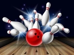 Red bowling ball hitting pins