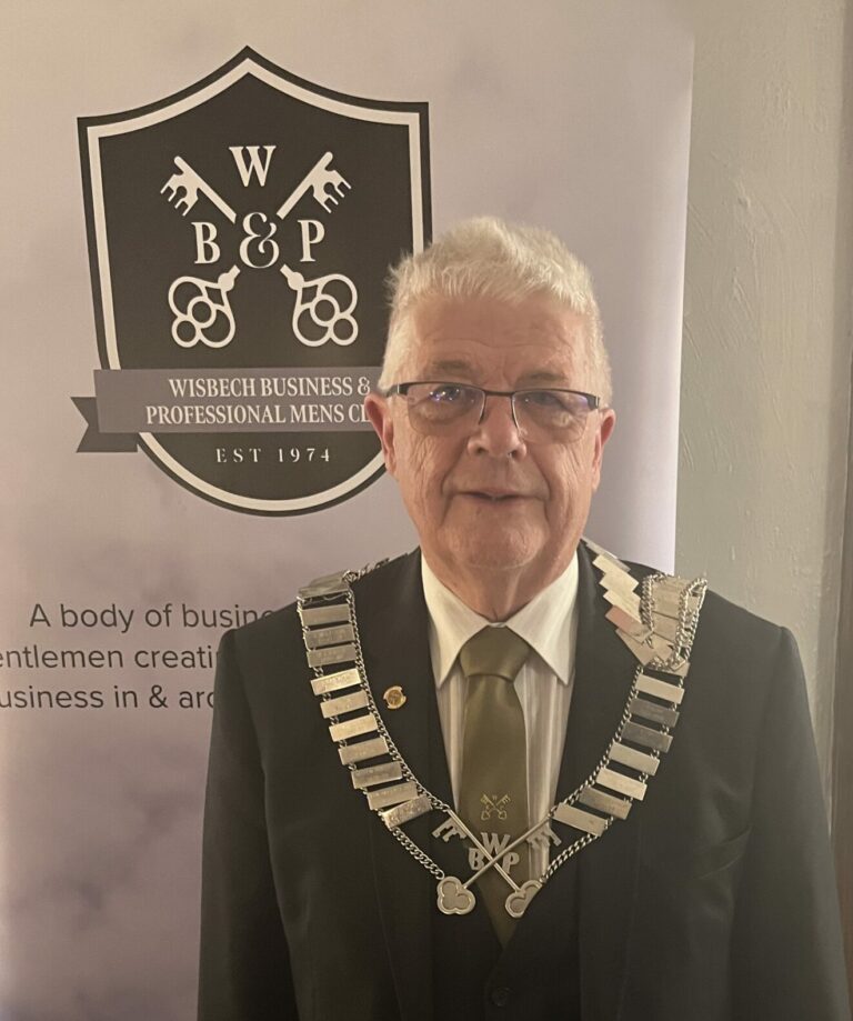 Man in official attire with banner background