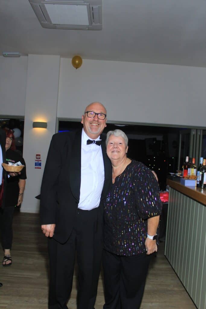 Two people smiling at a party