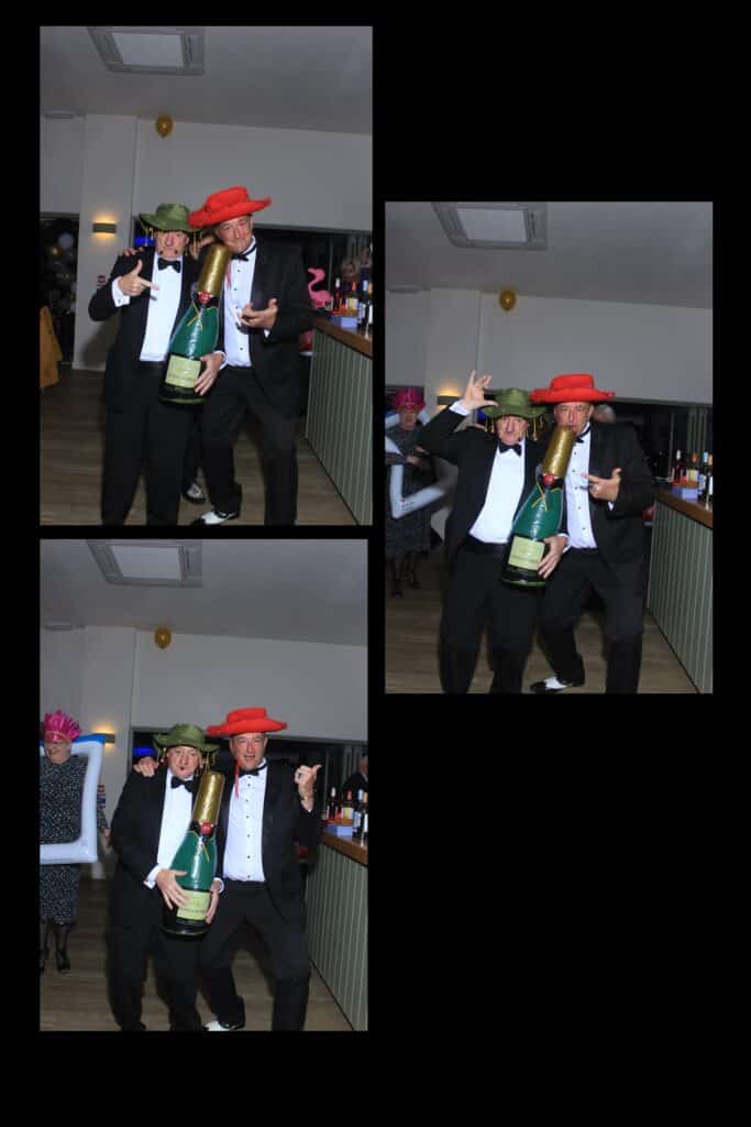 Men in hats holding oversized champagne bottle at party