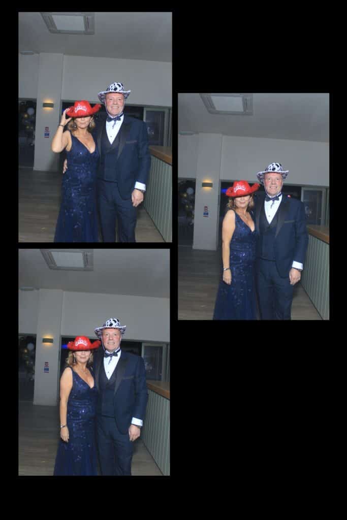 Couple in formal attire wearing hats at event.