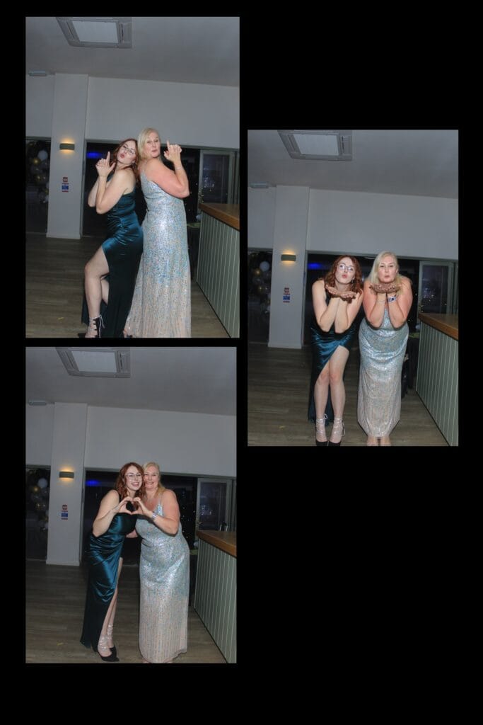 Two women posing in evening gowns at a party.