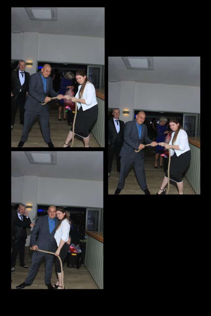Two people playing tug of war indoors.